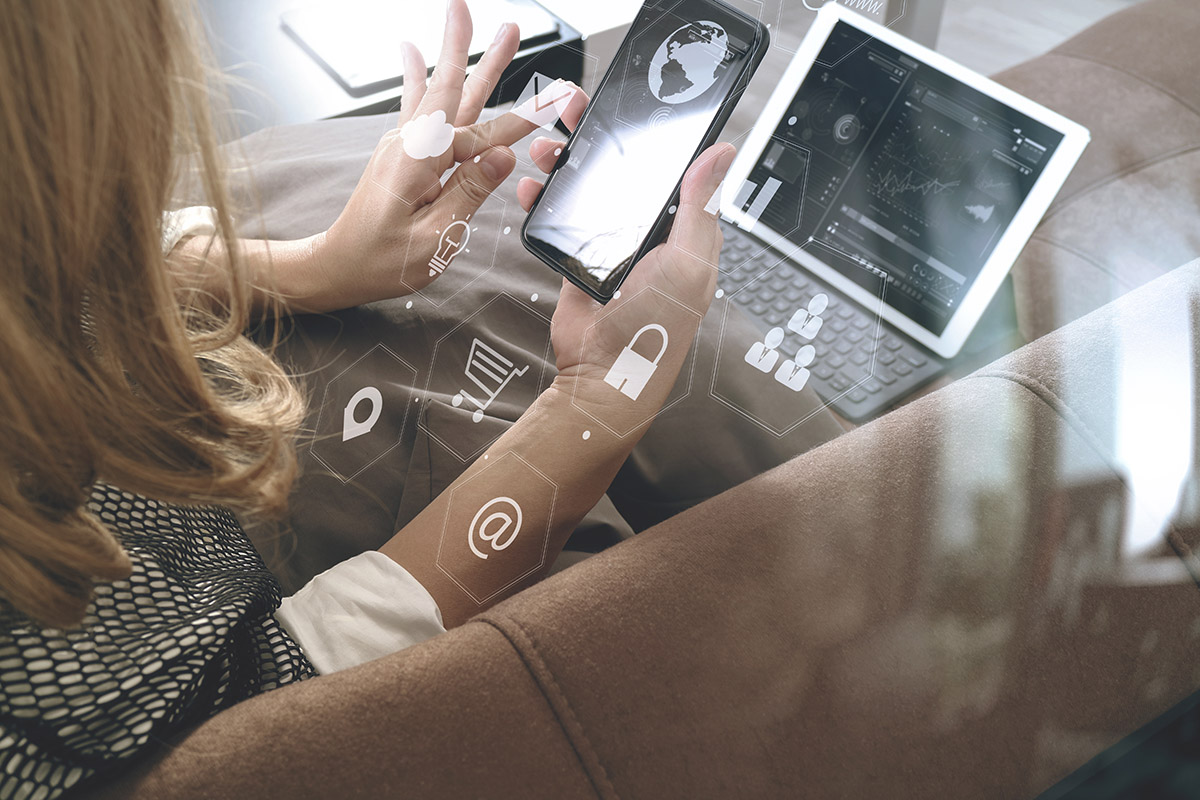 brunette woman using smart phone and digital tablet computer on