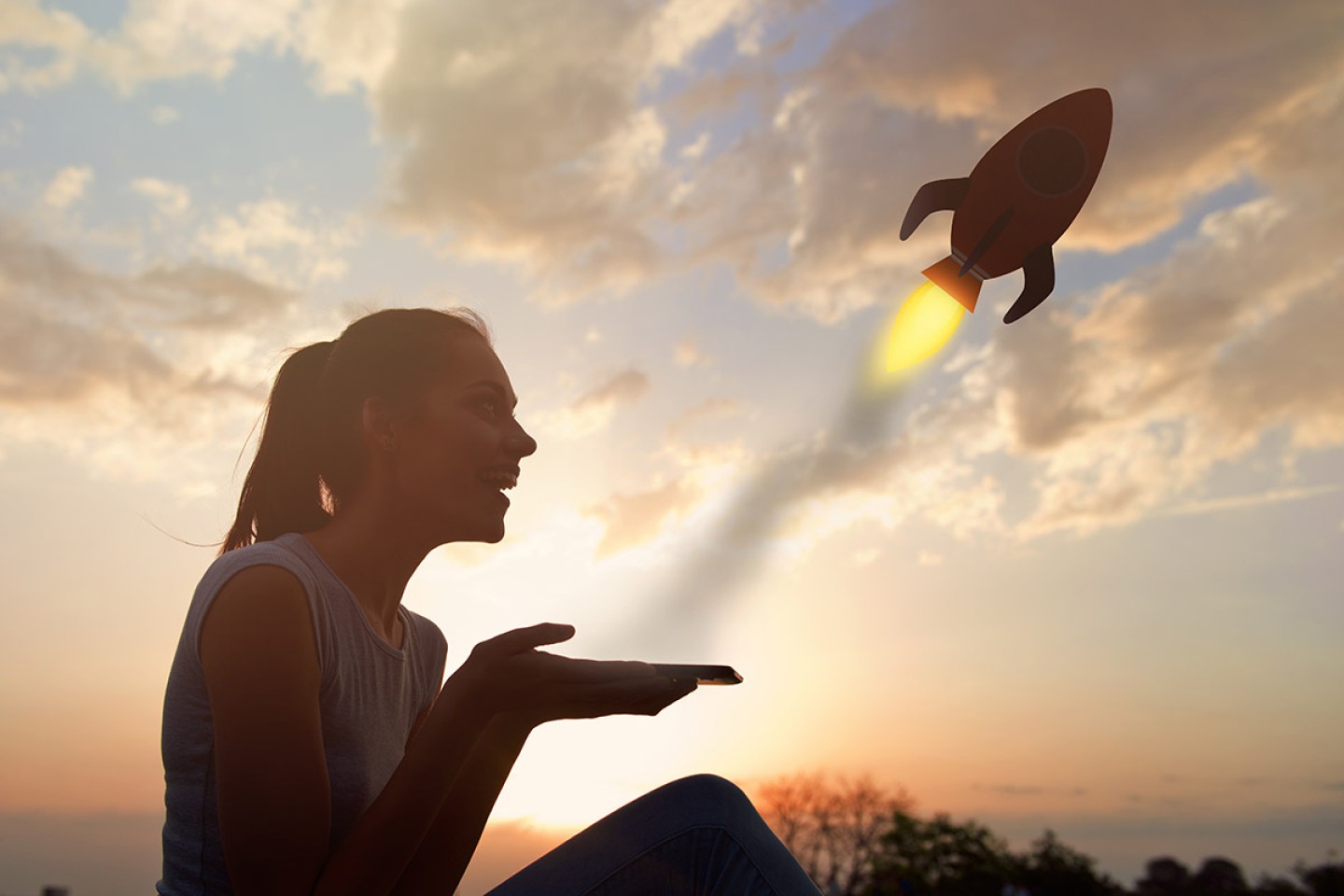 Beautiful young woman sitting outdoors, using a tablet, fun star